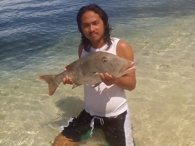 Fisherman from Pamilacan with big fish in his hands