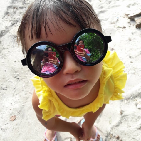 Baby Jane with sunglasses on the beach of Pamilacan
