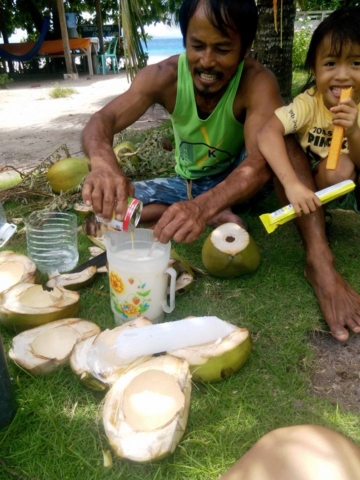 Junior and Baby Jane making buko juice in Pamilacan